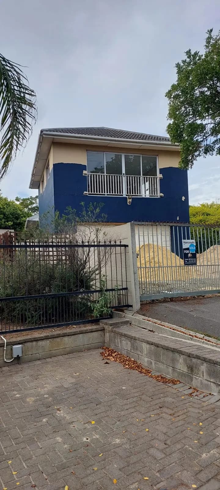 Double storey home repainted in navy blue and cream