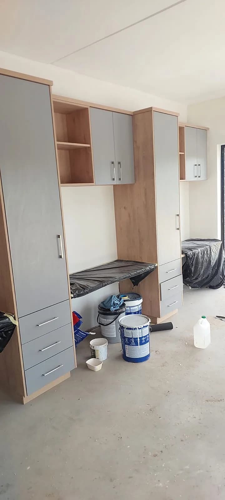 Kitchen walls painted around new cupboards before handover