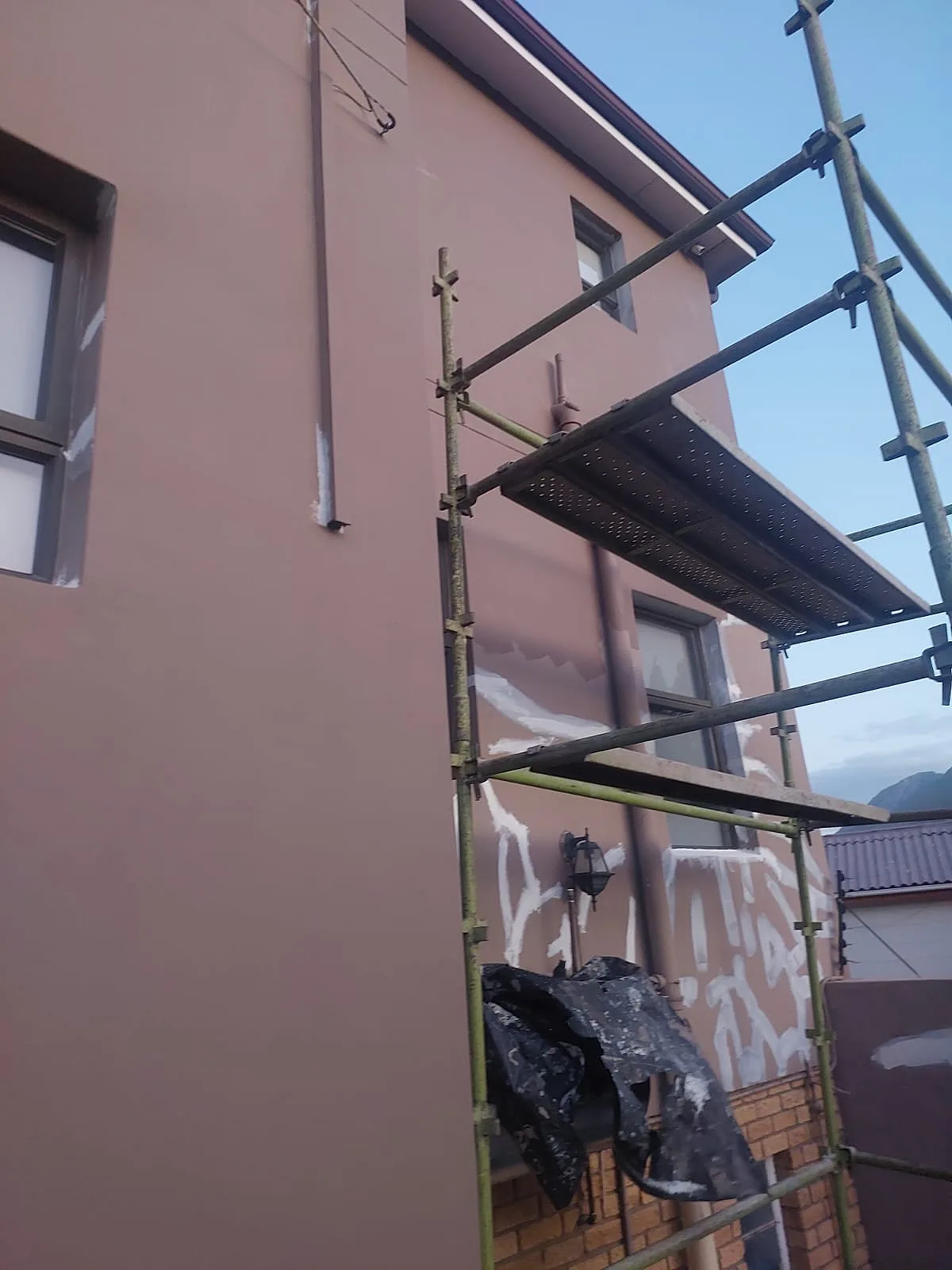 Scaffolding set up for exterior wall painting on a double storey