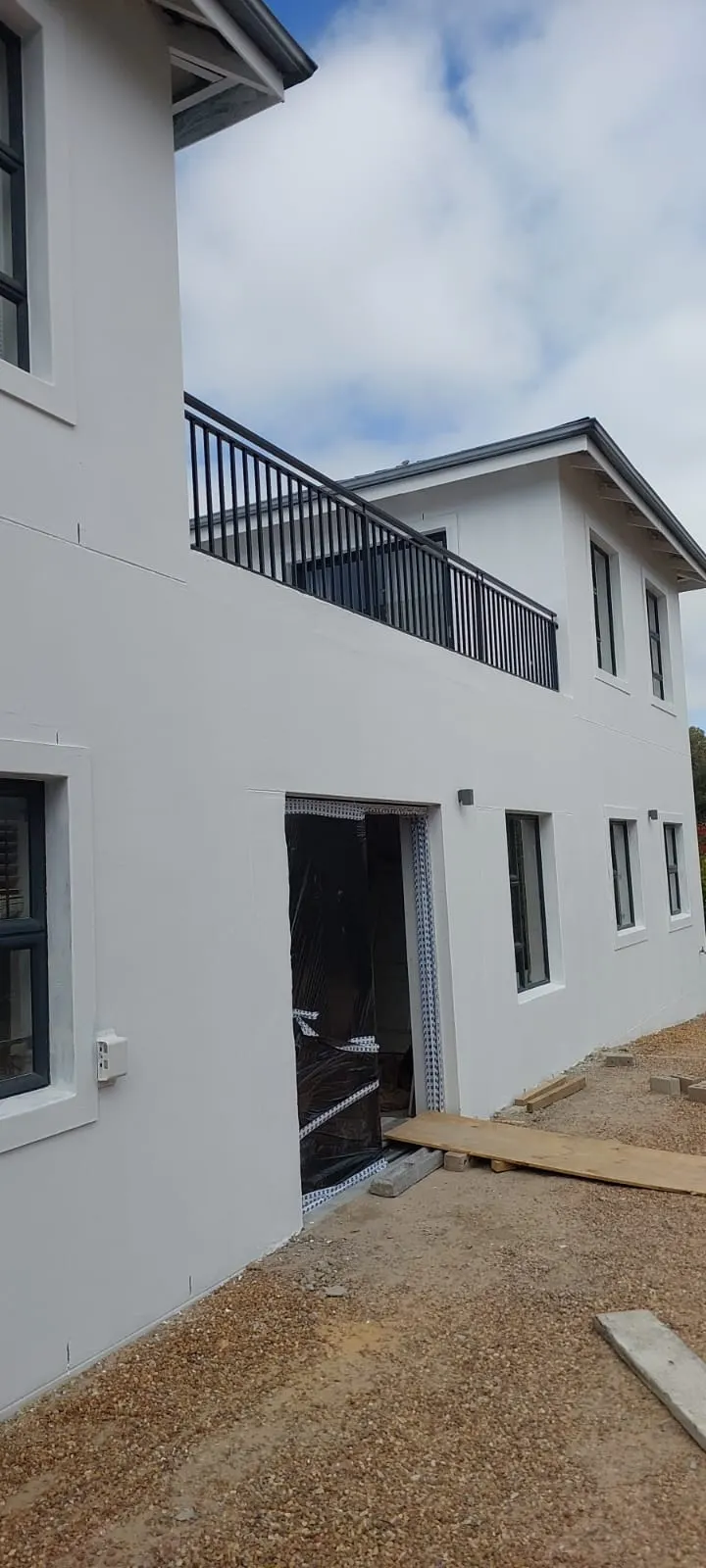 White exterior painting with black balustrades