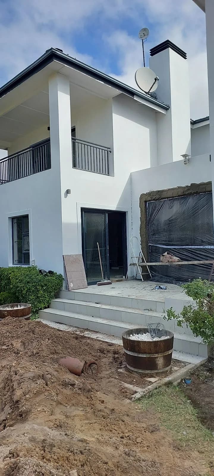 Rear of a white double storey home after exterior painting